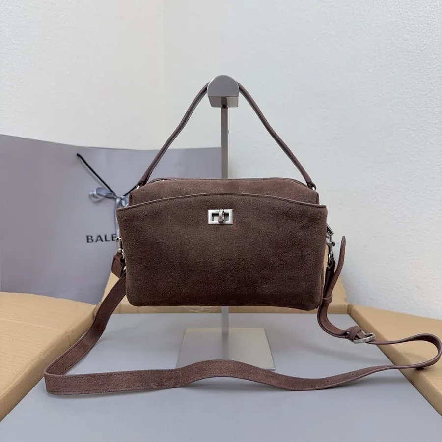 Balenciaga suede crossbody bag catalog photo with adjustable strap