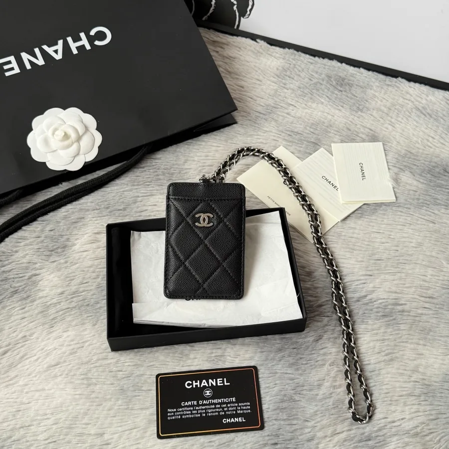 Chanel card holder in black caviar-grained leather with silver-tone hardware and a front flap