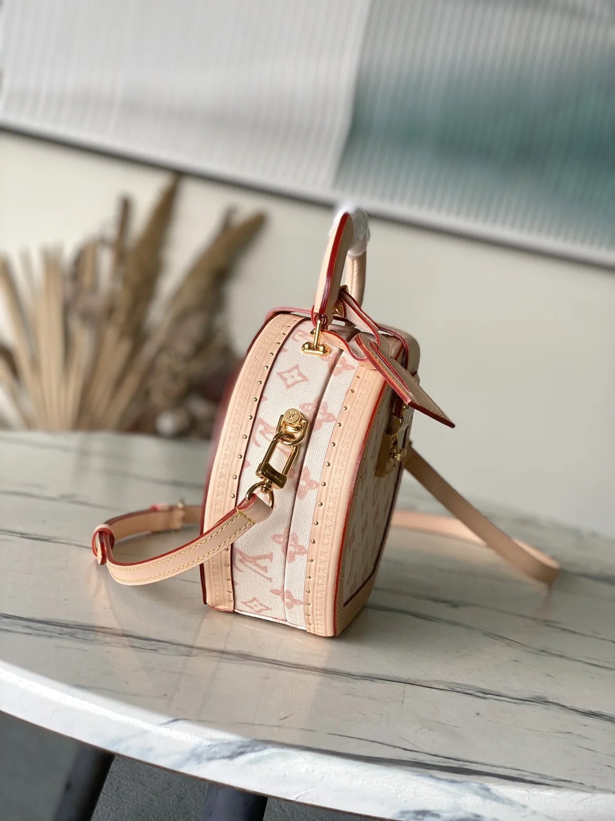 LV Boîte Chapeau side profile showing depth and adjustable shoulder strap