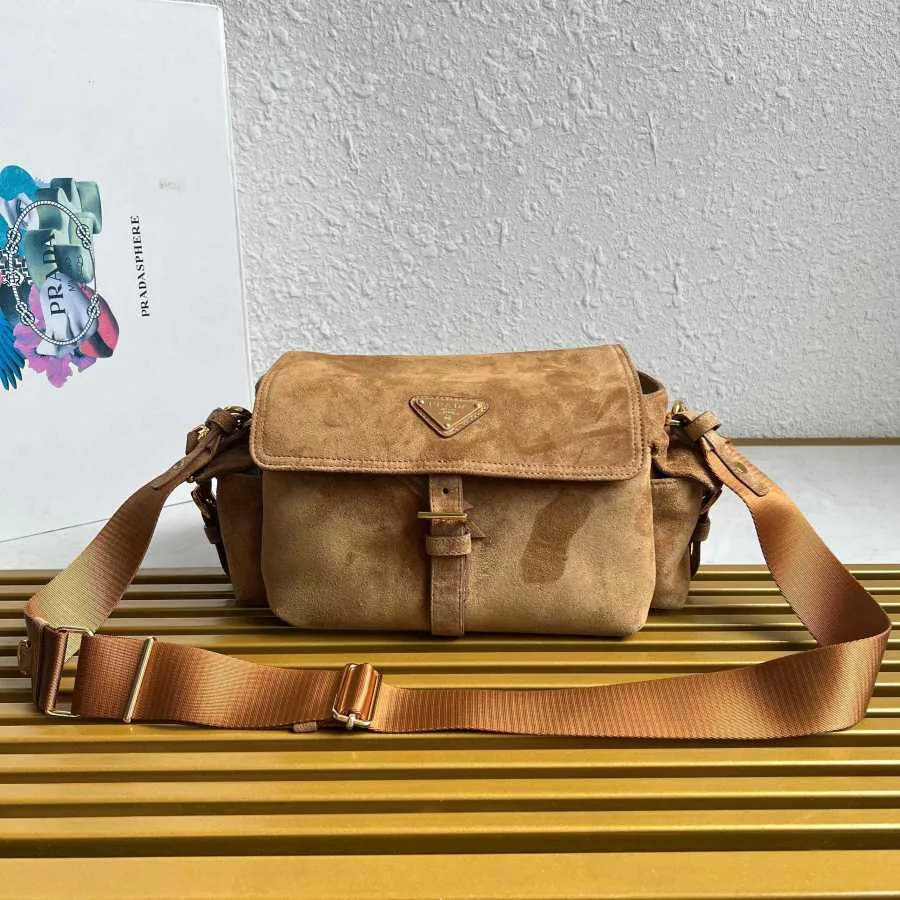 Prada Re-Edition-style nylon shoulder bag with a chain handle and woven strap, front view — catalog reference