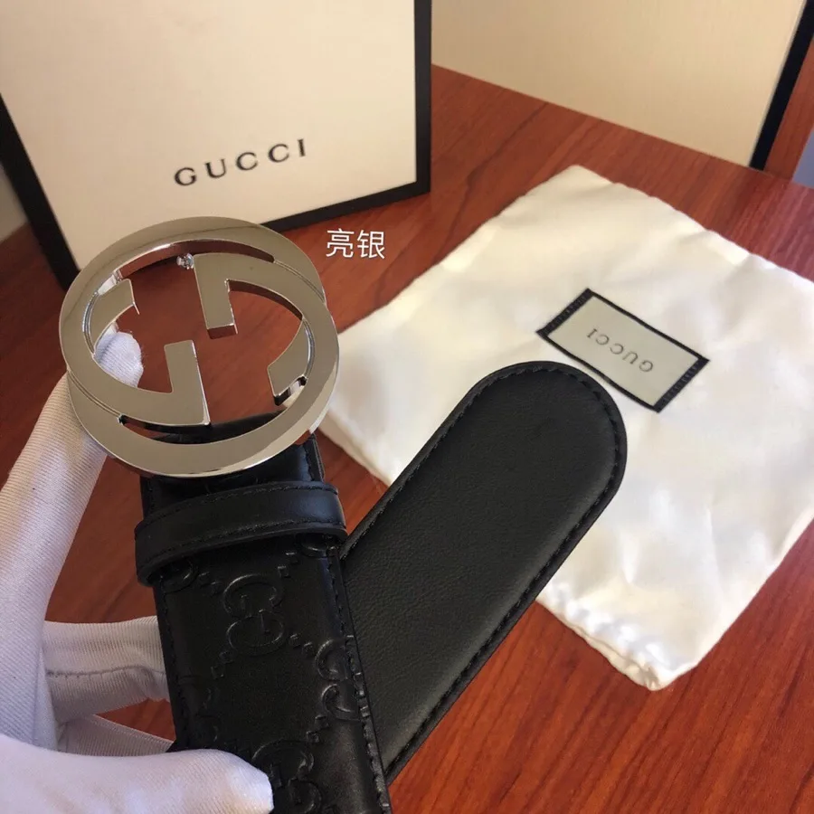 Gucci black leather belt with a silver-tone interlocking G buckle, embossed GG pattern on the strap and a black keeper loop, from the GunongTrade catalog