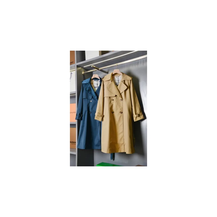 Long honey-beige Burberry trench coat photographed on a hanger, with double-breasted buttons and belted cuffs
