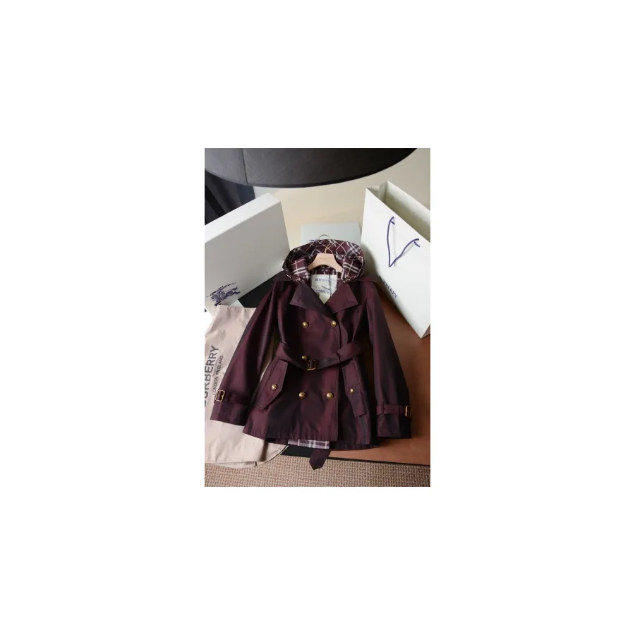 Burgundy Burberry trench coat with a hood, double-breasted front, belt and check lining