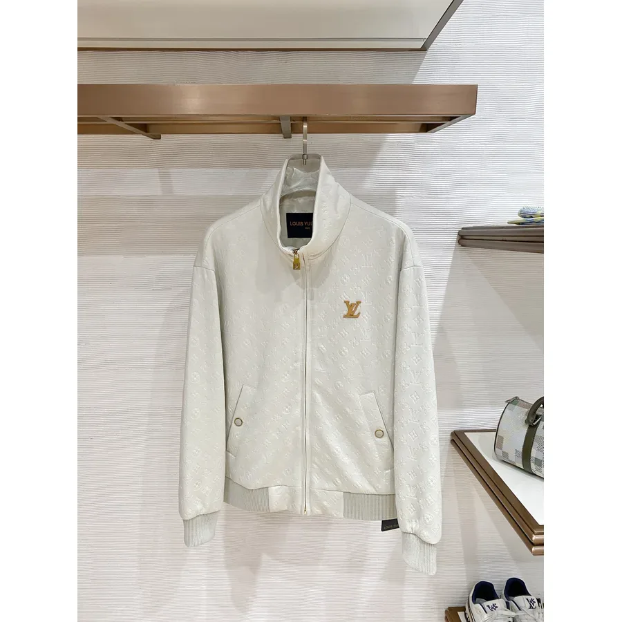 White zip-up jacket with a stand collar and gold-tone hardware, photographed flat