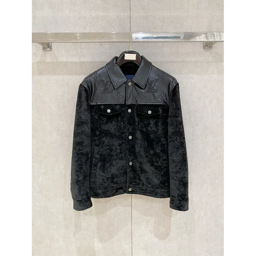 Black jacket with a monogram-patterned body, a smooth leather yoke and two chest pockets