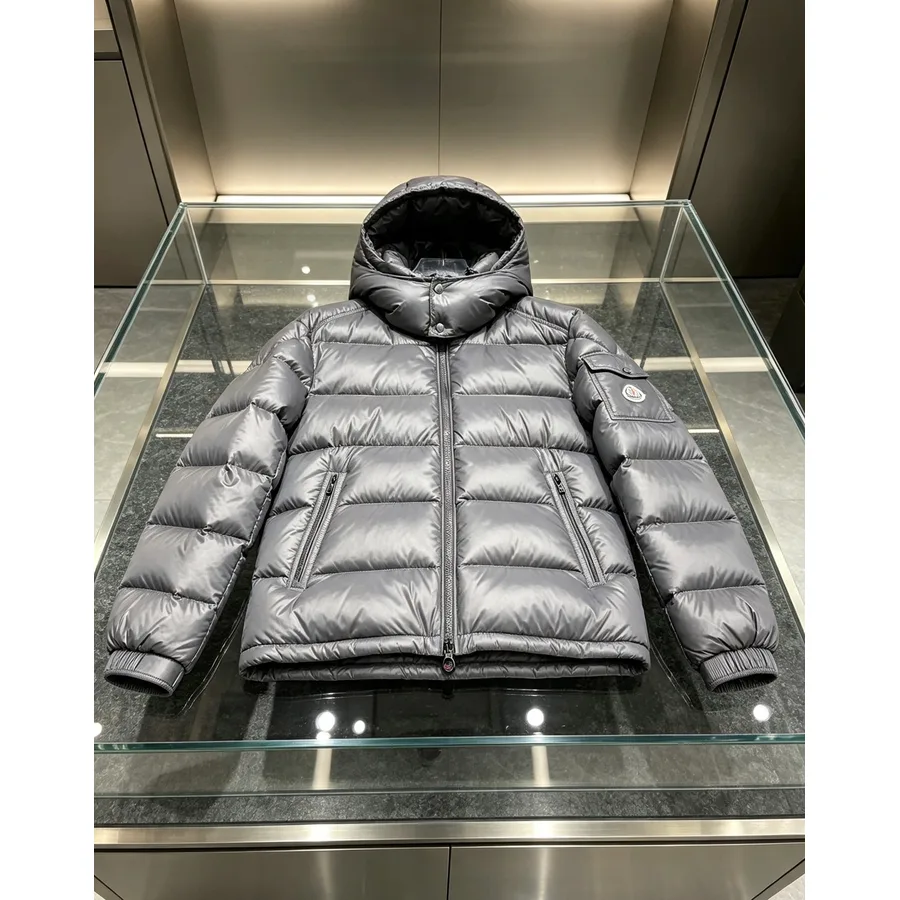 Glossy grey Moncler hooded down jacket with horizontal quilting and a circular sleeve badge
