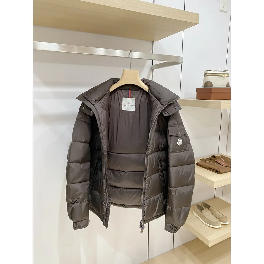 Dark brown Moncler down jacket with a matte shell, hood and elasticated cuffs