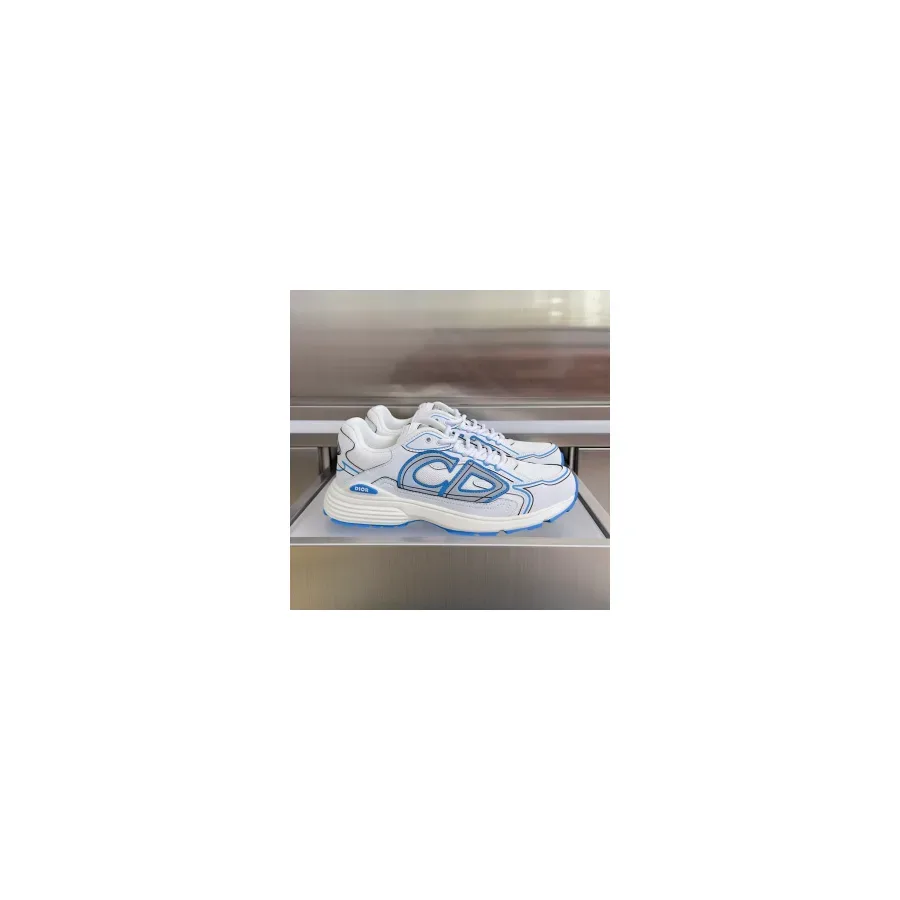 White Dior B30 low-top sneaker with mesh and fabric upper, blue overlays and a sculpted white and blue rubber sole