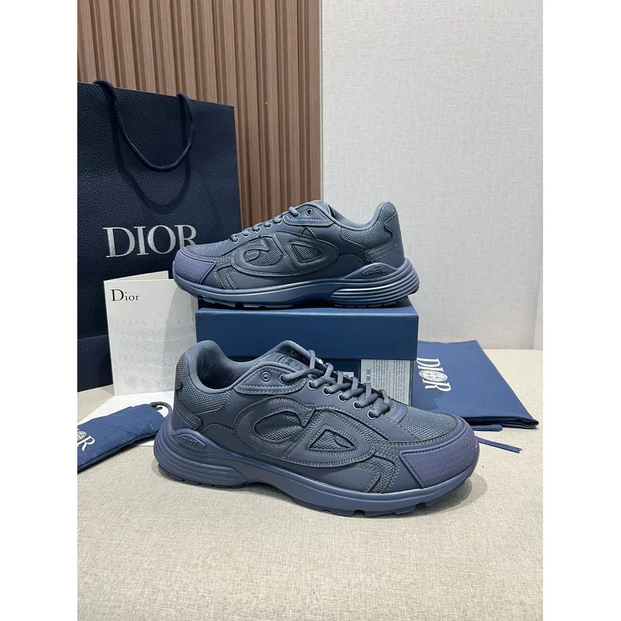 Dark navy Dior B30 sneaker with a mesh and synthetic upper and a chunky sculpted navy rubber sole, tonal CD logo on the side