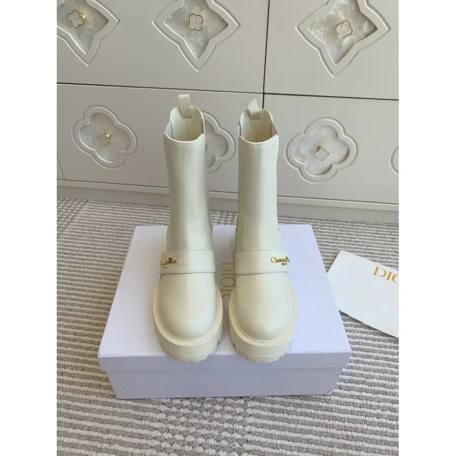 Cream leather Dior ankle boot photographed side on, showing the shaft height above the sole